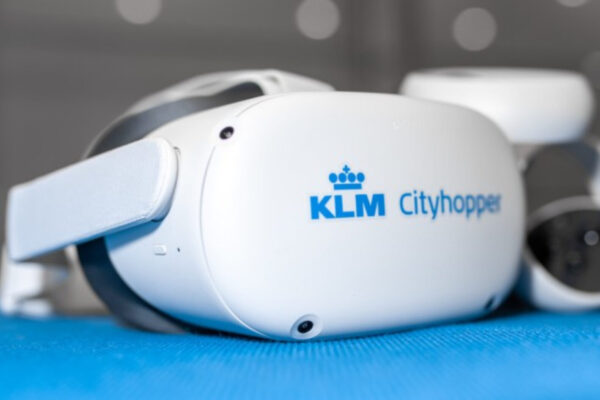 White virtual reality goggles with the KLM logo in blue